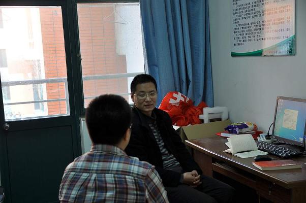 辅导员陈银吨在宿舍值班室与学生谈话 郑健摄影